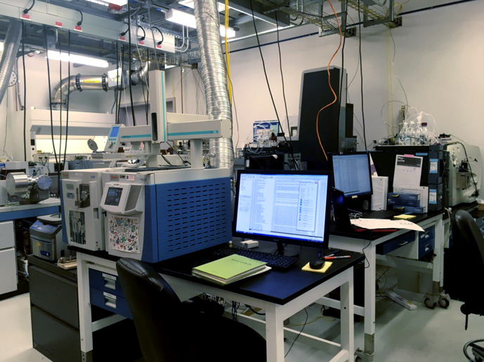 Computers and machinery sitting on lab benches.
